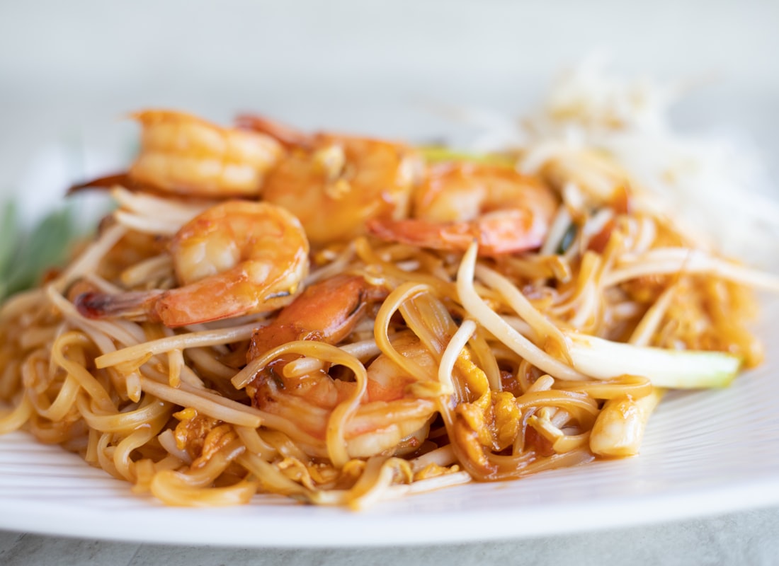 A plate of pad thai with lime and peanuts, from the Night Market build
